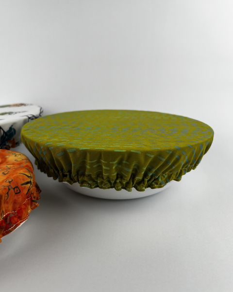 Green fabric bowl cover stretched over a white bowl