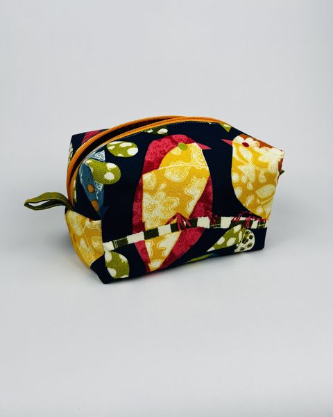 Boxy zipper pouch in a navy print with large yellow and red birds